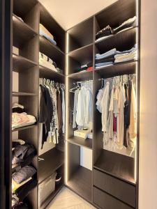 een inloopkast gevuld met veel kleren bij Kamanina Luxury Apartment in Odessa