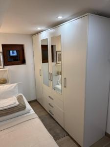 a bedroom with a white cabinet and a bed at Noel in Vukovar