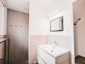 a bathroom with a sink and a mirror at La Ressource, Claire in Fontguenand