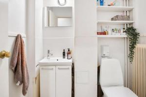 ein weißes Badezimmer mit Toilette und Waschbecken in der Unterkunft Spaceous room in Majorstuen central Oslo by subway in Oslo
