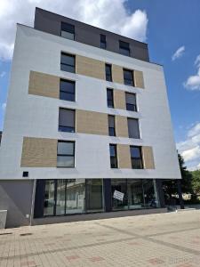 een groot wit gebouw met ramen aan de zijkant bij Apartmán Central Point 1 in Humenné