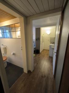 a hallway of a bathroom with a toilet and a sink at DG-Ferienwohnung nähe Legoland, mit großer Terrasse in Sontheim an der Brenz +14 photos
