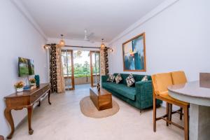a living room with a green couch and a table at Sithagi River Front Villa Weligama in Weligama