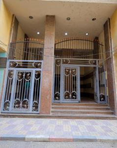 a building with gates on the front of a building at First Site OF Pyramids View & Jacuzzi in Cairo