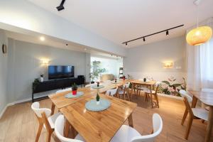 a living room with a wooden table and chairs at EPIC Vila Brașov, Cristian in Braşov