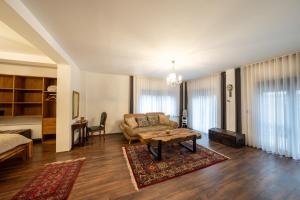a living room with a couch and a coffee table at Doa Boutique Hotel in Peje