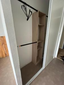 a door to a closet with a refrigerator at Hyper centre parking privé in La Roche-sur-Yon