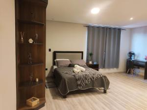 a bedroom with a bed with a teddy bear on it at Holy Home in Cochabamba