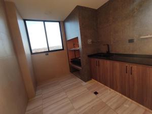 a small kitchen with a sink and a window at Holy Home in Cochabamba +34 photos
