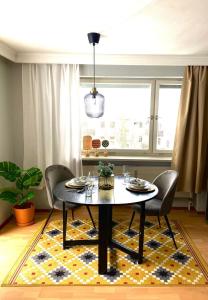a dining room with a table and chairs on a rug at FeWo Alpsee Hornweg in Immenstadt im Allgäu