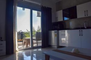a kitchen with a large sliding glass door to a patio at Quiet Corner Apartment in Luxor