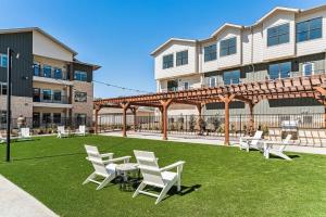een groep stoelen op een gazon voor een gebouw bij Landing Apartments - Leander in Leander