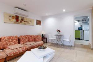 a living room with a couch and a table at Studio indépendant en villa Calme, Jardins et Piscine à 5 min de la Mer in Nice