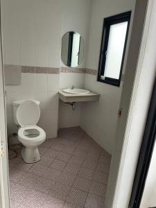 a bathroom with a toilet and a sink at CİMELi Guest House in Patong Beach +16 photos