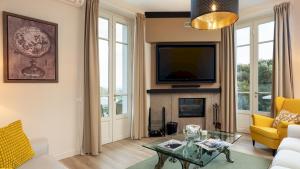 een woonkamer met open haard en tv bij VILLA FRANCESCA 10, Emma Villas in Volterra