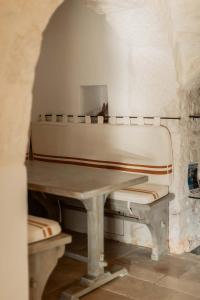 a white piano sitting in a room with a table at Regina di Ulivi in Ostuni