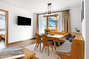 a living room with a table and a dining room at Wohnung Hochfelln in Ruhpolding