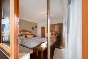 a small bedroom with a bed and a glass door at Wohnung Hochfelln in Ruhpolding