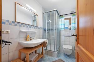 a bathroom with a sink and a shower and a toilet at Wohnung Hochfelln in Ruhpolding +23 photos