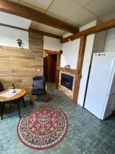 a living room with a table and a refrigerator at Studio JAVOR pod Tatrami in Jezersko +35 photos
