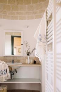 a bathroom with a sink and a mirror at Regina di Ulivi in Ostuni +131 photos