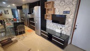a kitchen with a refrigerator and a counter top at Flat mobiliado e bem localizado in Recife
