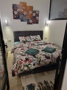 a bedroom with a bed with a comforter on it at Apartman Best Zlatar in Ciganska Mahala