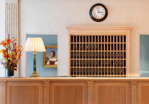 a large wooden wine rack with a clock on the wall at Brenners Park Hotel & Spa, Oetker Hotels in Baden-Baden