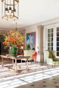 a living room with a table and a vase with flowers at Brenners Park Hotel & Spa, Oetker Hotels in Baden-Baden +108 photos