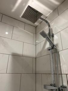 a shower with a shower head in a bathroom at Studio 1 in Howden +9 photos