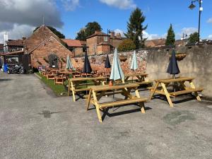 a row of picnic tables with umbrellas on them at Studio 1 in Howden