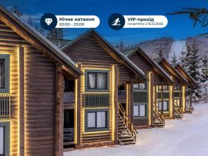 a row of log homes in the snow at Bukovel Hotel in Bukovel