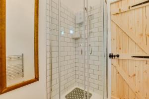 a shower in a bathroom with a mirror at 1 Bed in Duloe oc-l30057 in Duloe