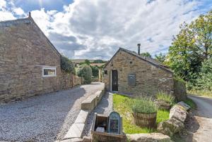 a stone building with a sign next to a street at 1 Bed in Duloe oc-l30057 in Duloe