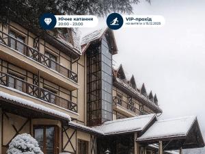 a building covered in snow with two signs on it at Edelweiss in Yaremche