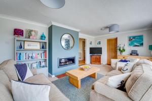 a living room with a couch and a table at 3 Bed in Fowey oc-tidewa in Fowey