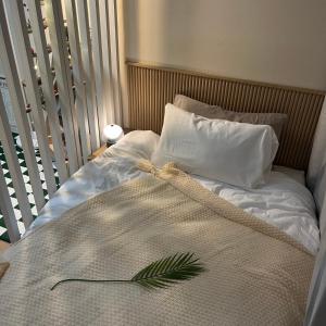 a bed with a blanket and two pillows on it at 부천역300m 코지하우스 in Sosa