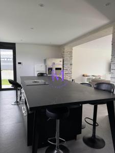 a large black table in a room with chairs at Villa Manosque in Les Ponts-de-Cé +15 photos