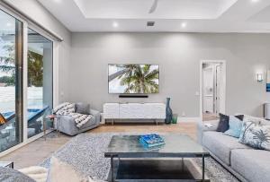 ein Wohnzimmer mit Sofa und Tisch in der Unterkunft Spacious Three Bedroom Lakeside Home with Relaxed Coastal Comfort in Palm Beach Shores