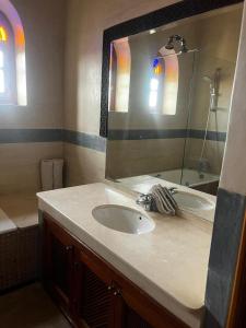 a bathroom with a sink and a mirror at Villa Oum Palace in Marrakesh +8 photos