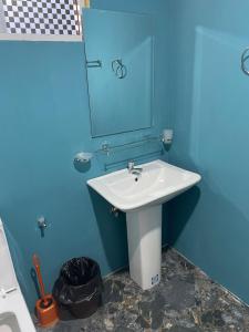 une salle de bains avec un lavabo blanc et un miroir dans l'établissement Femingo by Costels, à Hiriketiya 5 autres photos