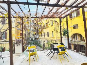 ローマにあるSina Rent Roomのパティオ(黄色の椅子、テーブル付)