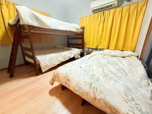 En eller flere senge i et værelse på Okayama Urban Peach