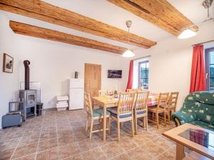 a kitchen and dining room with a table and chairs at Nová Hájovna in Říčky