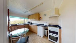a kitchen with a sink and a stove top oven at C37 Jupiter, Riviere Towans in Hayle +10 photos