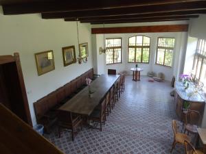 a large dining room with a long table and chairs at Keleti Kúria in Neszmély