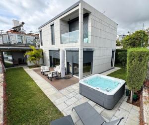 a house with a hot tub in the yard at Square house in Funchal