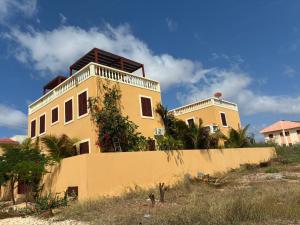 a yellow building with a balcony on top of it at A casa do Amor in Vila do Maio