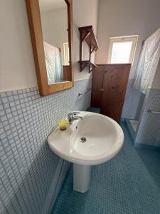 a bathroom with a white sink and a mirror at A casa do Amor in Vila do Maio +62 photos