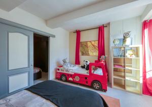 een kinderkamer met een rode brandweerwagen als laadbak bij Black & White in Alignan-du-Vent